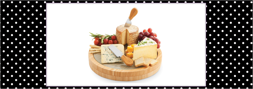 A large wooden centerpiece with assorted cheese and cheese knives